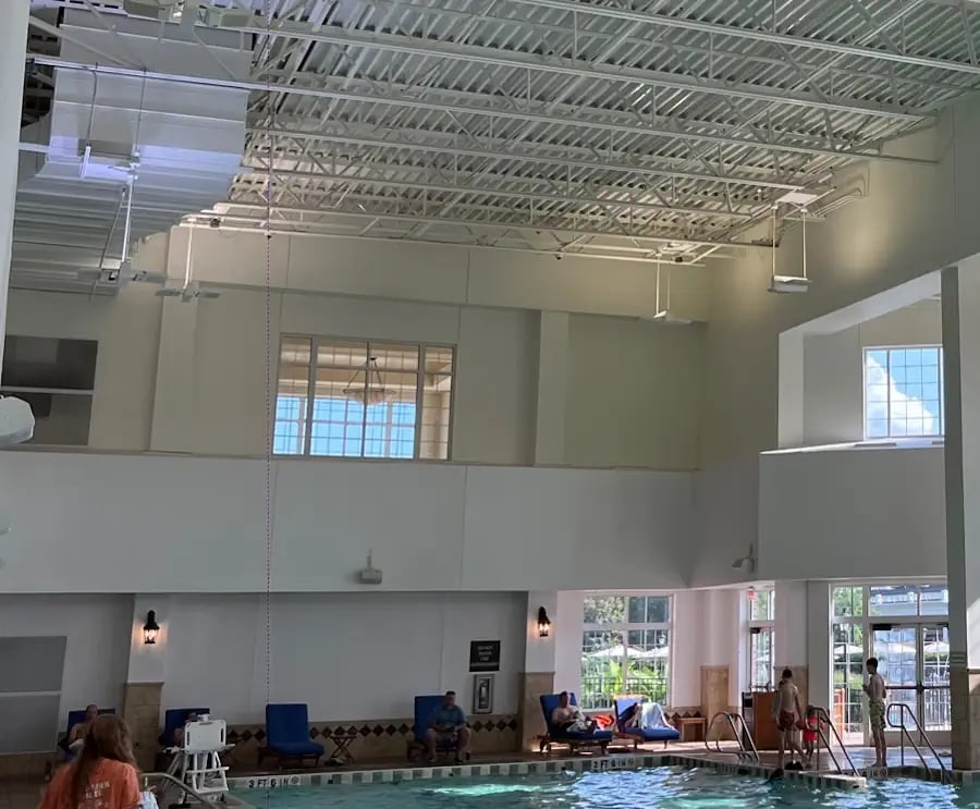 Swimming Pool & Aquatic Facility LED Lighting in 2026: What Commercial Buyers Get Wrong Indoor commercial swimming pool with overhead LED lighting