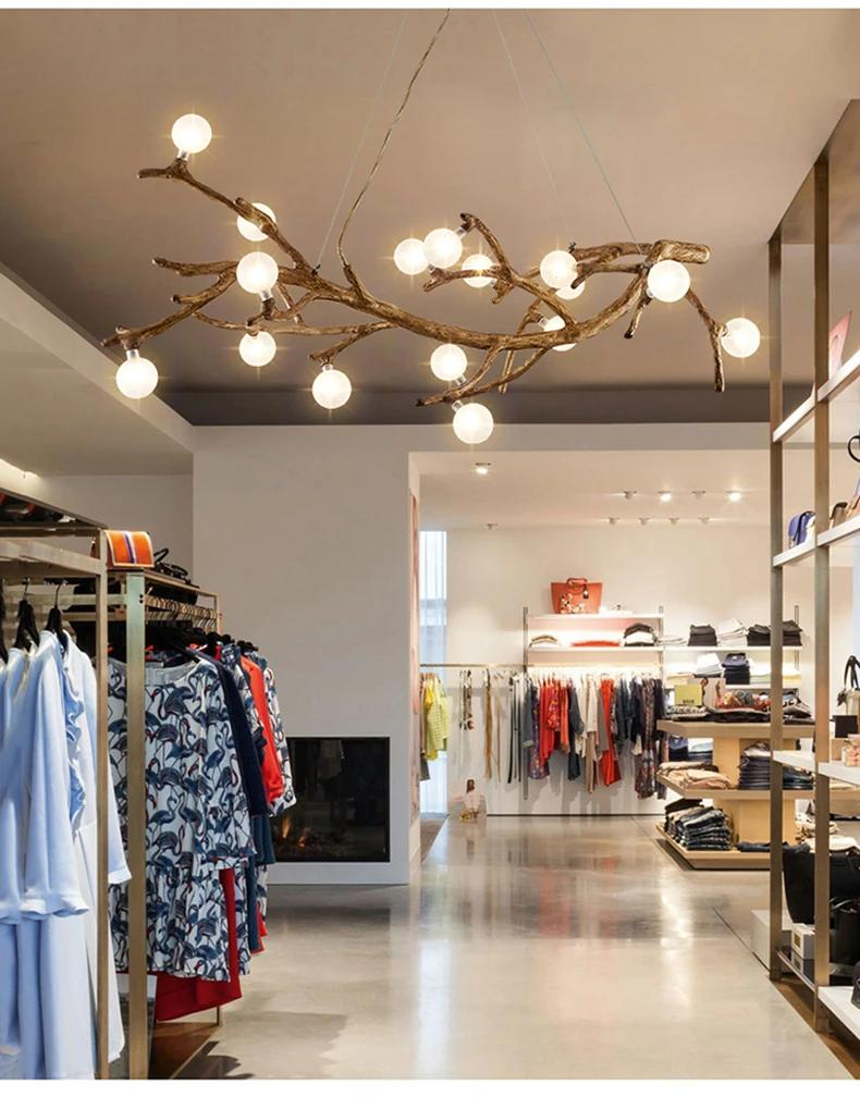Retail Store Fixture Lighting in 2026: Why Your Shop Looks Wrong Clothing store interior with pendant and accent lighting