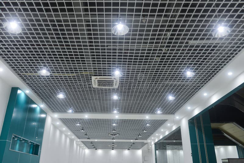 Commercial office ceiling with installed LED downlights and grid ceiling
